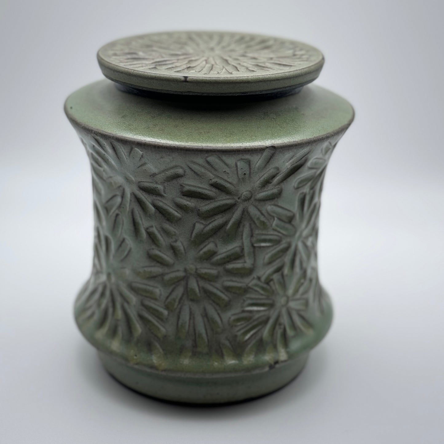 Lidded jar with carvings