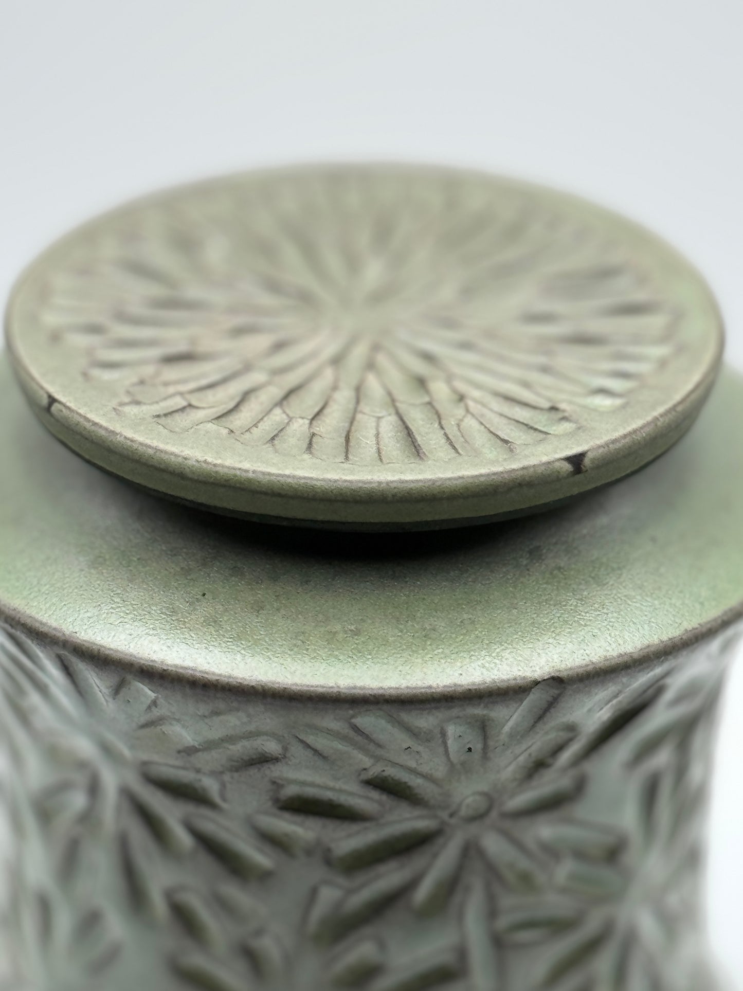 Lidded jar with carvings